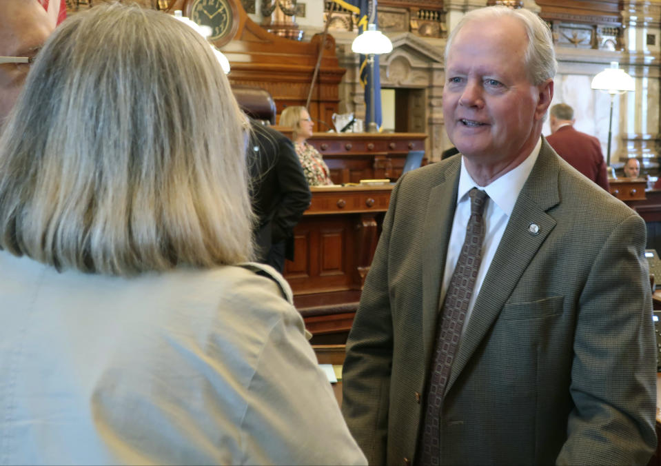 Kansas state Sen. Gene Suellentrop, right, R-Wichita, speaks to GOP colleagues before the Senate convenes, Friday, May 3, 2019, at the Statehouse in Topeka, Kansas. Suellentrop, chairman of the Senate health committee is an opponent of a Medicaid expansion plan favored by Democratic Gov. Laura Kelly. (AP Photo/John Hanna)