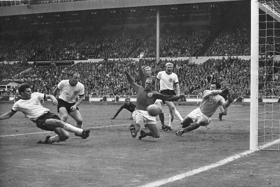 FILE - In this July 30, 1966 file photo Germany's Wolfgang Weber, left, side foots the ball past England's goalkeeper Gordon Banks, right, to equalise the score at two goals each, at Wembley Stadium, London. England won its only World Cup title by beating West Germany in London in a match that produced an enduring moment of controversy that is still the subject of debate. In extra time with the scored even at 2-2, Alan Ball crossed to England teammate Geoff Hurst, who turned and shot. The ball thumped down from the underside of the West German crossbar and Roger Hunt raised his arms to proclaim the ball bounced over the goal line. (AP Photo/Bippa)