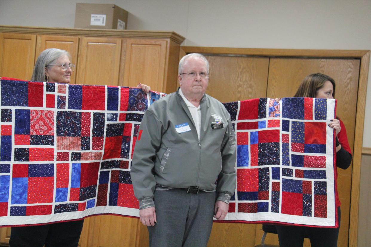 Larry Vodenik receives a Quilt of Valor from the Perry Piecemakers Quilt Guild during a presentation on Friday, Nov. 10, 2023, at the Perry Elks Lodge.