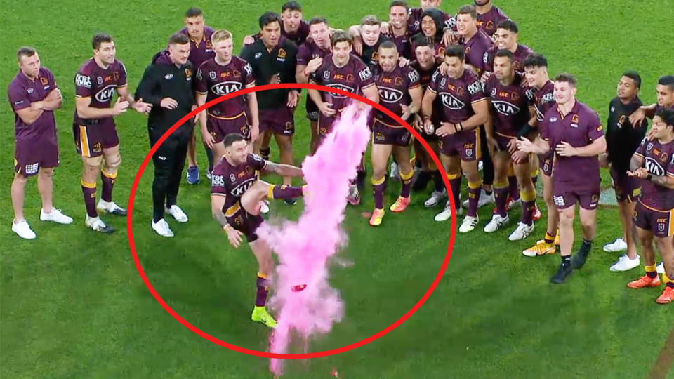 Darius Boyd kicks a football for a gender reveal stunt after the Broncos match.