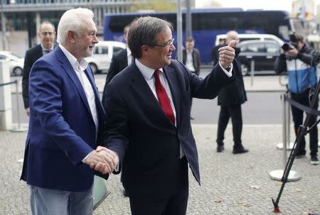 Minister President of North Rhine-Westphalia Armin Laschet shakes hands with vice chairman of the Free Democratic Party (FDP) Wolfgang Kubicki, as they arrive at the CDU headquarters for exploratory talks about forming a new coalition government in Berlin, Germany, November 18, 2017. REUTERS/Hannibal Hanschke