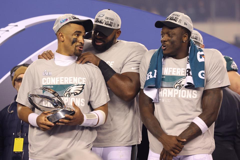 Philadelphia Eagles quarterback Jalen Hurts (left), defensive tackle Fletcher Cox (center) and wide receiver A.J. Brown (right) shown during the NFC Championship trophy presentation.