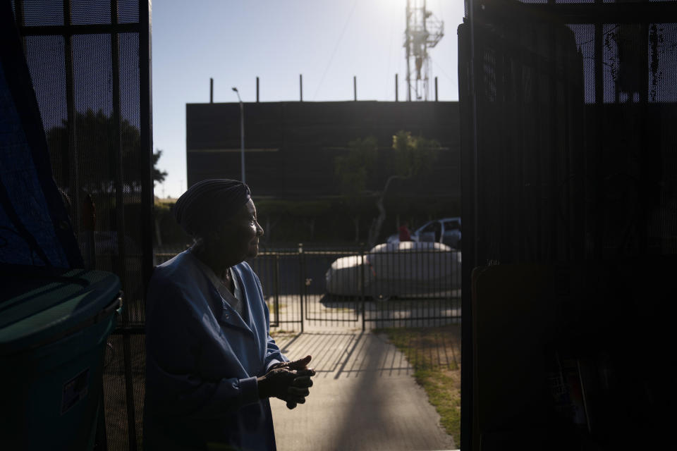 FILE - Q.C. Kelker, 83, stands at her home across the street from the Jefferson oil drill site Thursday, June 24, 2021, in Los Angeles. Los Angeles doesn't have pumpjacks dotting a desolate desert like western Texas. Its oil and gas operations are near places where people live and gather. On Wednesday, Jan. 26, 2022, the Los Angeles City Council approved a measure to ban new oil and gas wells and phase out existing ones. (AP Photo/Jae C. Hong, File)