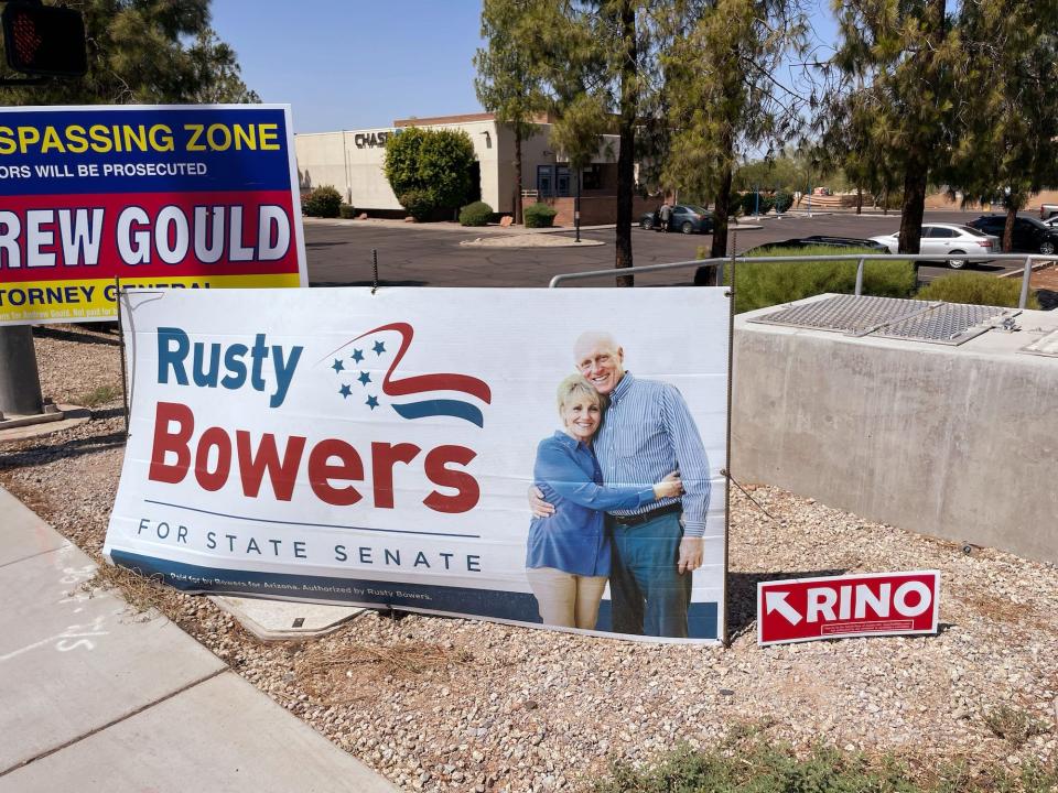 A yard sign for Rusty Bowers' state senate campaign with a "Republican in Name Only" sign placed next to it in Mesa, Arizona.