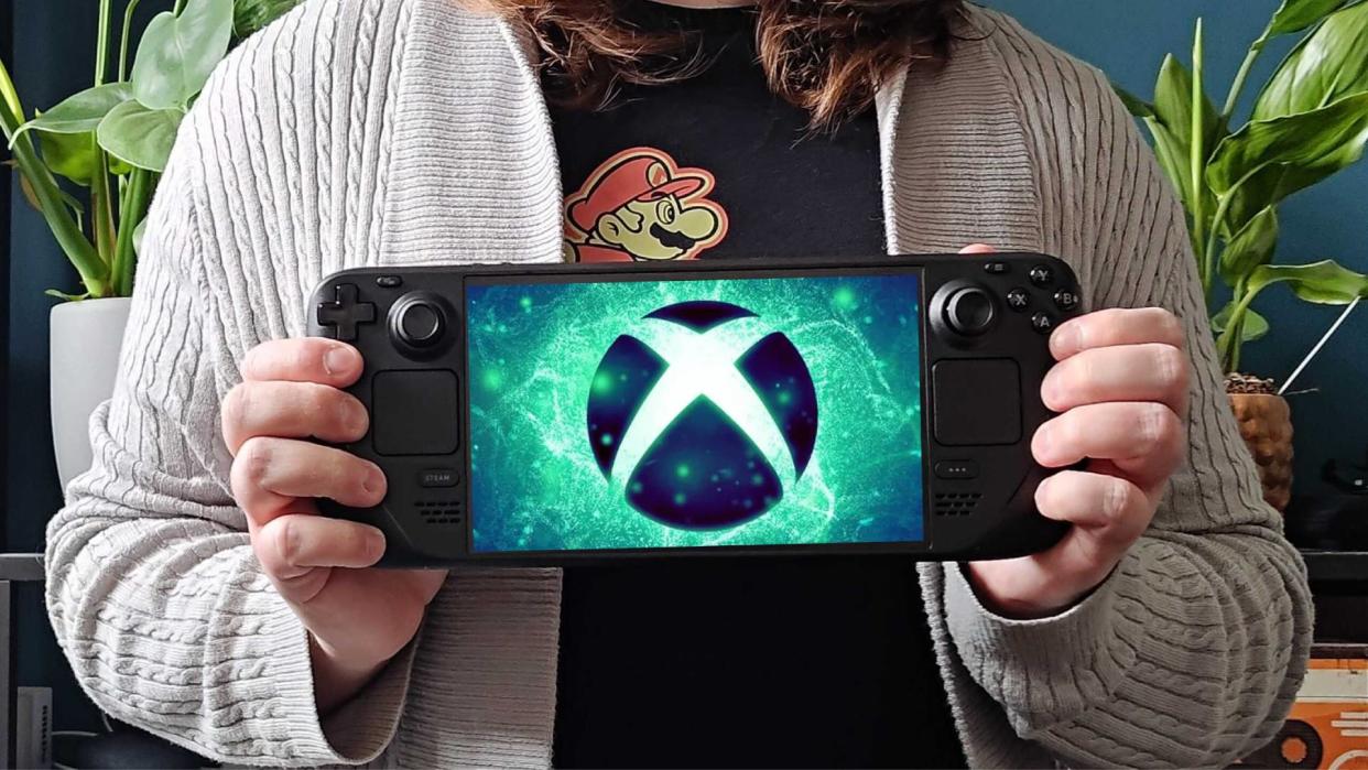  GamesRadar+ hardware editor Phil Hayton holding Steam Deck OLED with Xbox logo on screen. 