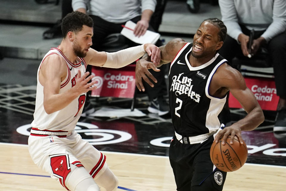 Los Angeles Clippers forward Kawhi Leonard, right, is fouled by Chicago Bulls guard Zach LaVine during the second half of an NBA basketball game Sunday, Jan. 10, 2021, in Los Angeles. (AP Photo/Marcio Jose Sanchez)