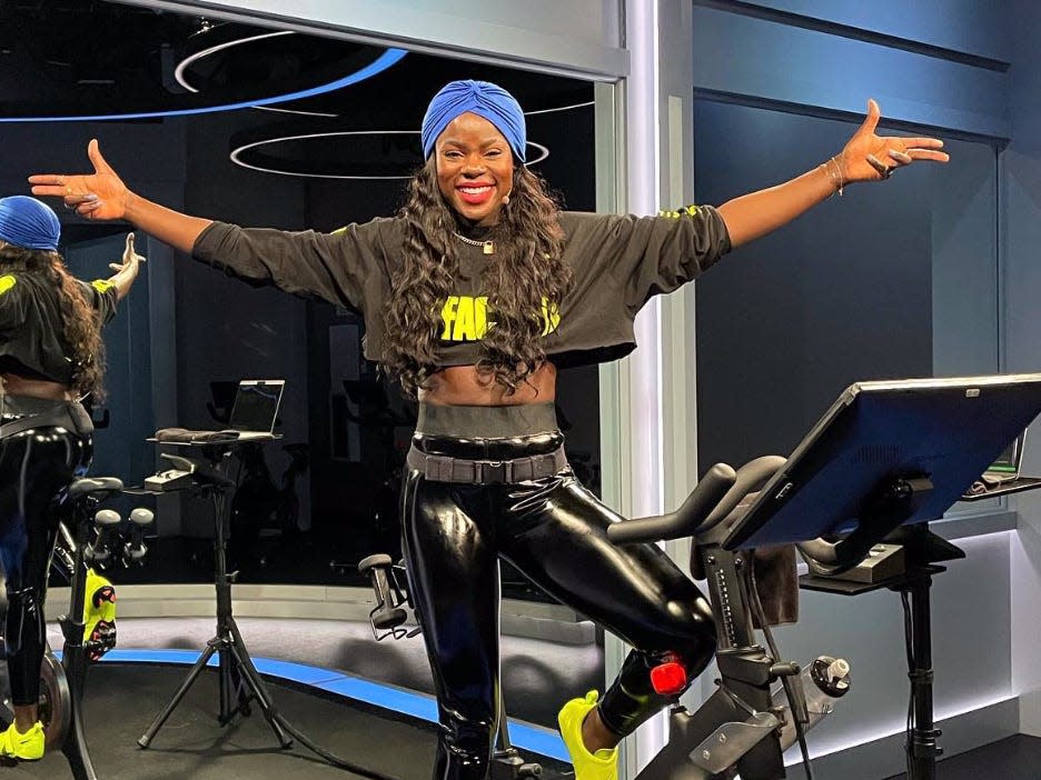 Tunde Oyeneyin in the Peloton studio on a bike