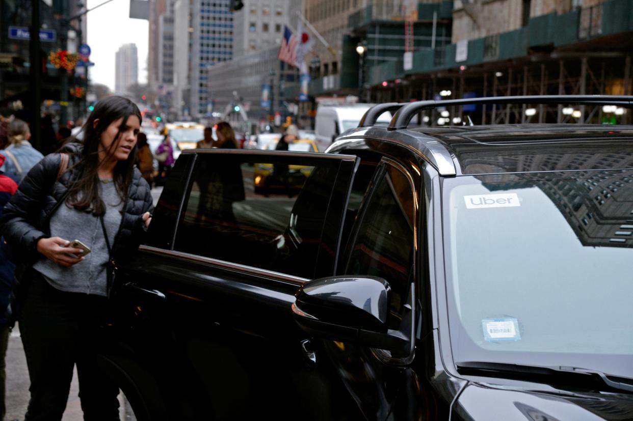 A passenger enters an Uber car in New York City, New York, U.S., December 6, 2019.