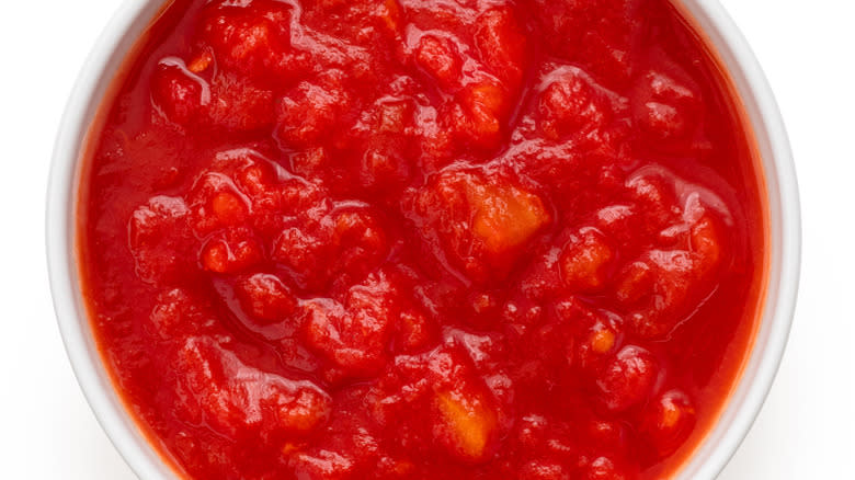 Canned tomatoes on white background