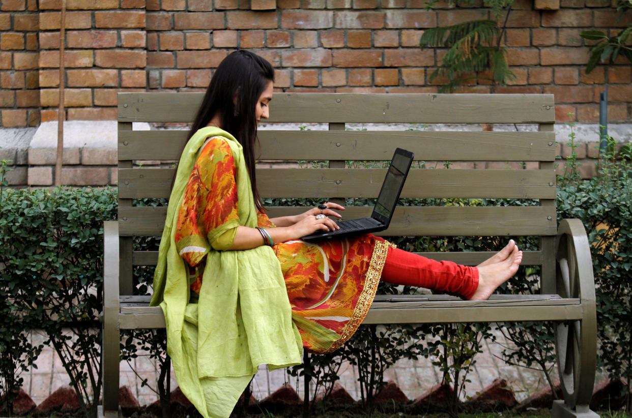 A woman works on a bench on Peshawar, Pakistan. Some experts say the rise of gig work is transforming women's role in the workforce. (Photo: Fayaz Aziz / Reuters)