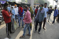 Migrant laborers from other states stand on a street looking for work on the outskirts of Jammu, India, Sunday, Sept.27, 2020. The nation of 1.3 billion people is expected to become the coronavirus pandemic's worst-hit country within weeks, surpassing the United States. (AP Photo/Channi Anand)