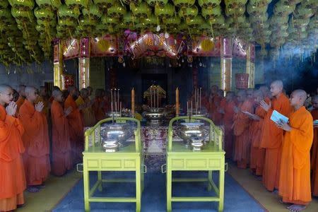Buddhist monks pray at a temple to mark the eve of the vegetarian festival in Bangkok's Chinatown, Thailand, October 19, 2017. REUTERS/Athit Perawongmetha