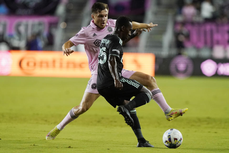 Inter Miami midfielder Indiana Vassilev (17) and Charlotte FC defender Harrison Afful (25) go after the ball during the first half of an MLS soccer match, Saturday, July 16, 2022, in Fort Lauderdale, Fla. (AP Photo/Marta Lavandier)