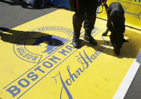 Boston Police dog "Titan" and his handler Officer Joel Rodriguez patrol the finish line of the Boston Marathon in Boston, Massachusetts April 20, 2014. REUTERS/Brian Snyder