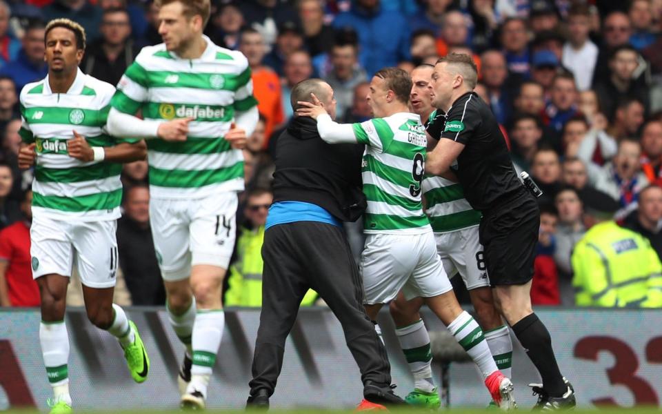  Fan invades the pitch before the game - Credit: REUTERS