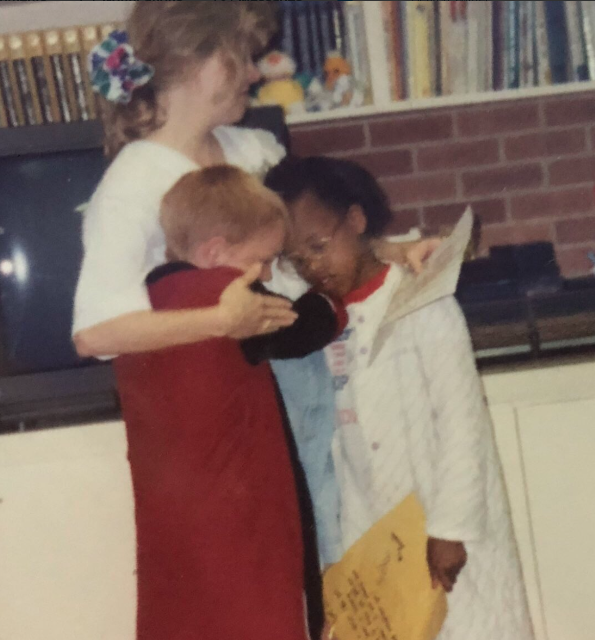 Dell Cameron, left, and another child hug a state employee. (Photo: Twitter)