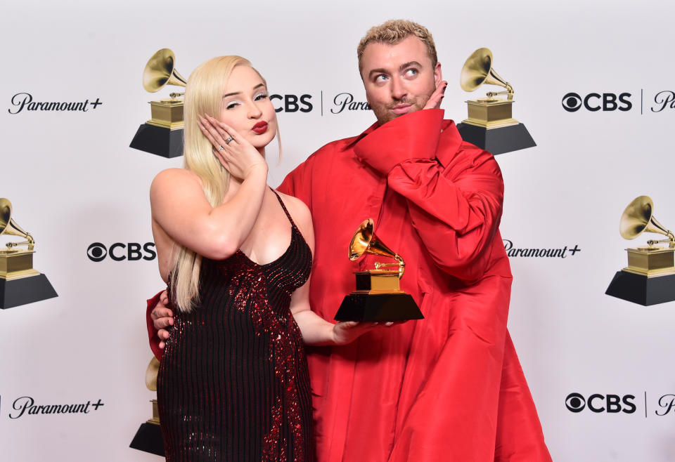 kim and sam holding their award