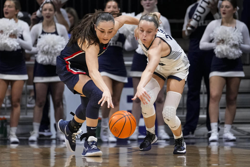 UConn guard Nika Muhl (10) makes a steal on Butler guard Kendall Wingler (55) during the first half of an NCAA college basketball game in Indianapolis, Tuesday, Jan. 3, 2023. (AP Photo/Michael Conroy)