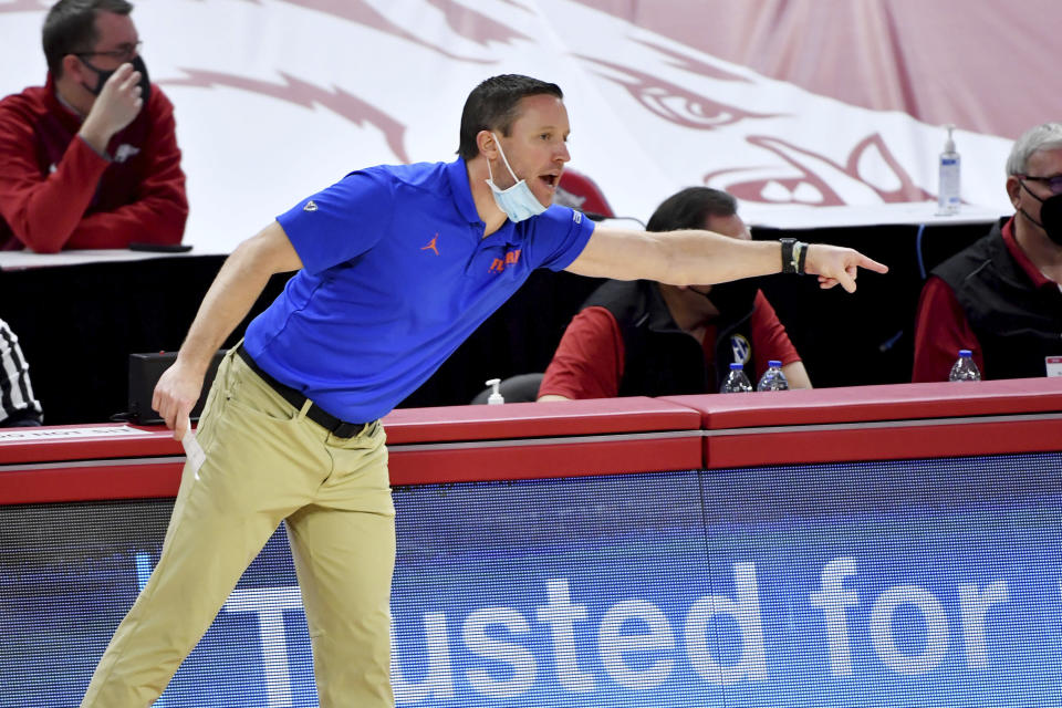 Florida coach Mike White instructs his team as they play Arkansas during the second half of an NCAA college basketball game in Fayetteville, Ark. Tuesday, Feb. 16, 2021. (AP Photo/Michael Woods)