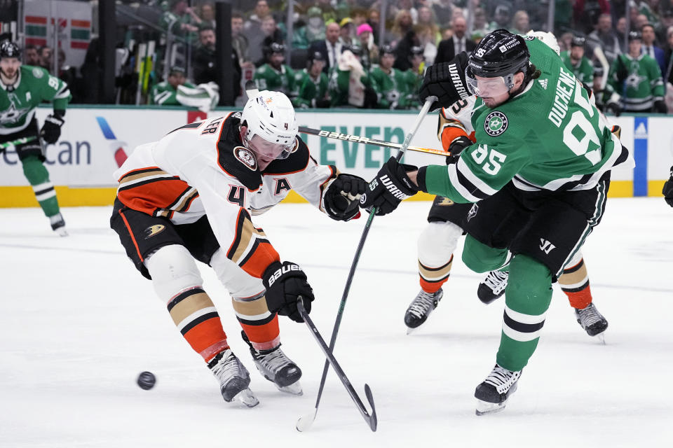 Anaheim Ducks defenseman Cam Fowler (4) deflects a shot by Dallas Stars center Matt Duchene (95) during the first period of an NHL hockey game in Dallas, Thursday, Jan. 25, 2024. (AP Photo/Tony Gutierrez)