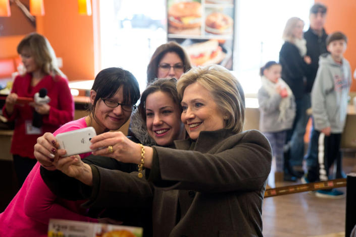<p>Democratic presidential candidate Hillary Clinton makes a selfie with customers, Feb. 7, 2016, at a Dunkin’ Donuts in Manchester, N.H. (Photo: Matt Rourke/AP)</p>