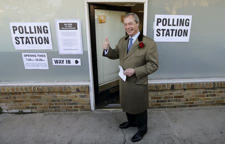 Nigel Farage, leader of the United Kingdom Independence Party (UKIP), gestures as he arrives to vote at his polling station in Ramsgate, southeast England, May 7, 2015. REUTERS/Suzanne Plunkett