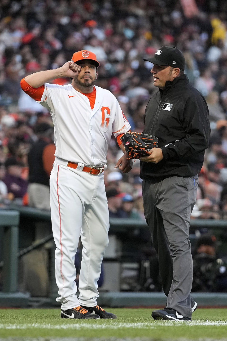 San Francisco Giants relief pitcher Jose Alvarez, left, gestures next to home plate umpire David Rackley after be taken out during the fourth inning against the Washington Nationals in a baseball game Friday, July 9, 2021, in San Francisco. (AP Photo/Tony Avelar)