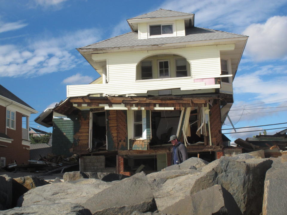 This Oct. 31, 2012 photo shows a home in Bay Head N.J. that was destroyed by Superstorm Sandy two days earlier. Rocks in the foreground had been buried under sand that washed away during the storm. On the 10th anniversary of the storm, government officials and residents say much has been done to protect against the next storm, but caution that much more still needs to be done to protect against future storms. (AP Photo/Wayne Parry)