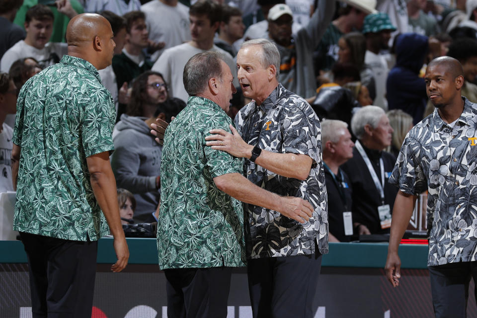 Tennessee coach Rick Barnes, center right, and Michigan State coach Tom Izzo, center left, talk following an NCAA college basketball exhibition game, Sunday, Oct. 29, 2023, in East Lansing, Mich Michigan State assistant coach Mark Montgomery, left, and Tennessee associate head coach Justin Gainey, right, look on. (AP Photo/Al Goldis)