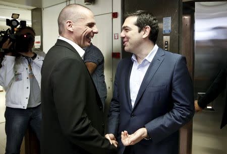 Greek Finance Minister Yanis Varoufakis (L) welcomes Prime Minister Alexis Tsipras for a meeting at the ministry in Athens, Greece May 27, 2015. REUTERS/Alkis Konstantinidis