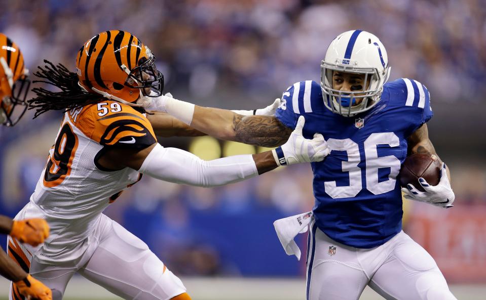 Colts running back Dan Herron runs against Bengals linebacker Emmanuel Lamur in 2015.