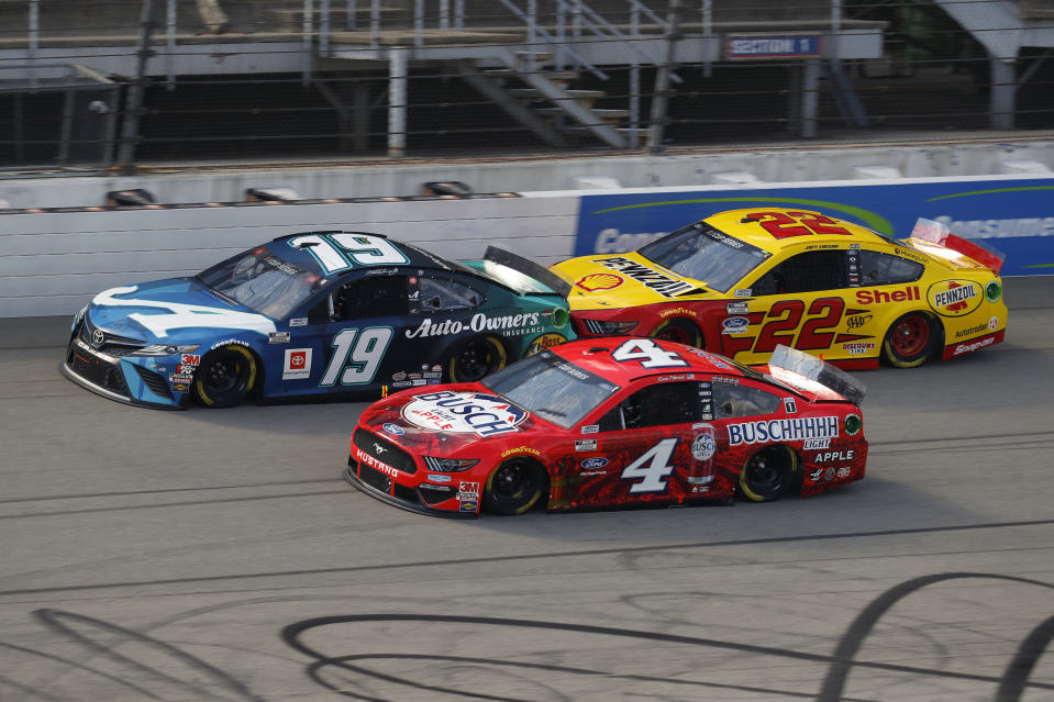 Kevin Harvick (4), Martin Truex Jr. (19) and Joey Logano (22) race during a NASCAR Cup Series auto race at Michigan International Speedway in Brooklyn, Mich., Sunday, Aug. 9, 2020. (AP Photo/Paul Sancya)