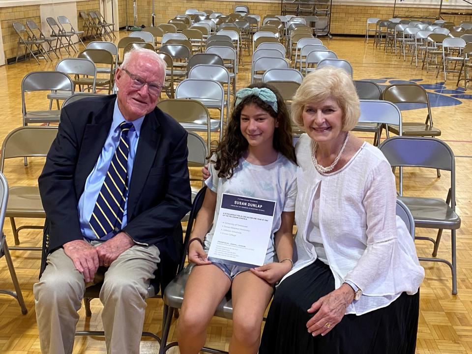 Photos by Patricia Sanchez Lee
Coraline Lee, center, poses with donor Joe Johnson, left, and principal Susan Dunlap after being chosen as the recipient of a future college scholarship named in honor of Dunlap.