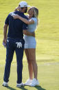 Dustin Johnson celebrates with his partner Paulina Gretzky on the 18th green after winning the Tour Championship golf tournament and FedEx Cup on Monday, Sept. 7, 2020 at East Lake Golf Club in Atlanta. (AP Photo/John Bazemore)