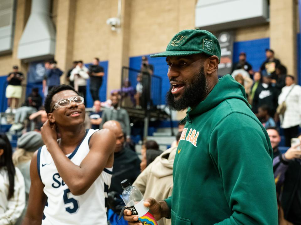 Bryce James talks to his dad, LeBron James, after the Sierra Canyon vs King Drew boys basketball game at Sierra Canyon High School on November 16, 2022 in Chatsworth, California.