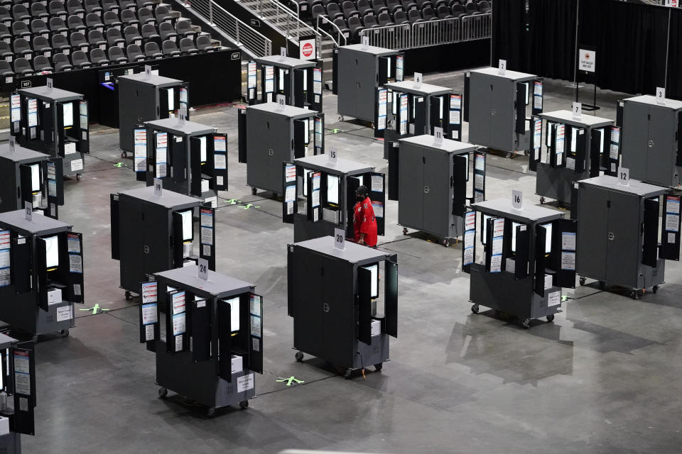 A man tries to vote early but can't because the machines stopped working during early voting at the State Farm Arena on Monday, Oct. 12, 2020, in Atlanta. (AP Photo/Brynn Anderson)