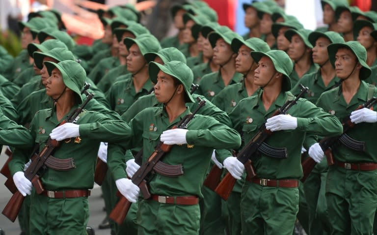 Soldiers dressed as Vietnam War era Vietcong soldiers march during a parade marking the 40th anniversary of the fall of Saigon, in Ho Chi Minh City on April 30, 2015