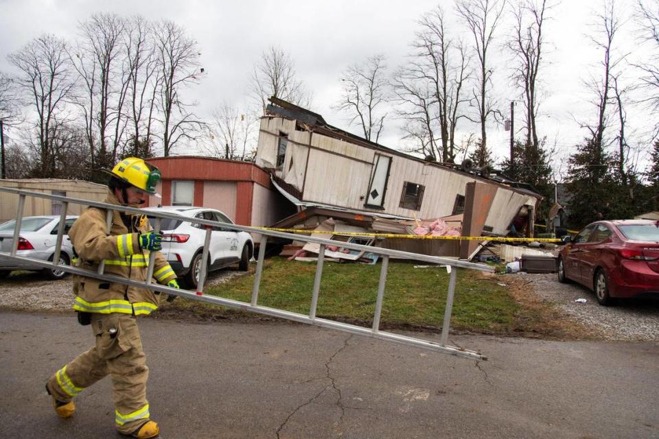 Firefighters work on marking mobile homes damaged and destroyed by a storm last night at Parkers Mobile Home Park in Stamping Ground, Ky., Saturday, December 6, 2021.