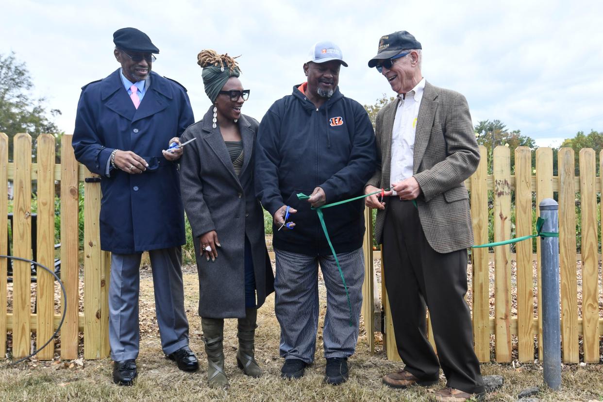 From left, Richard Brown Jr., Fameika Elliott, Chris Battle and L. Caesar Stair III cut the ribbon to the Payne Avenue Community Garden on Oct. 15.