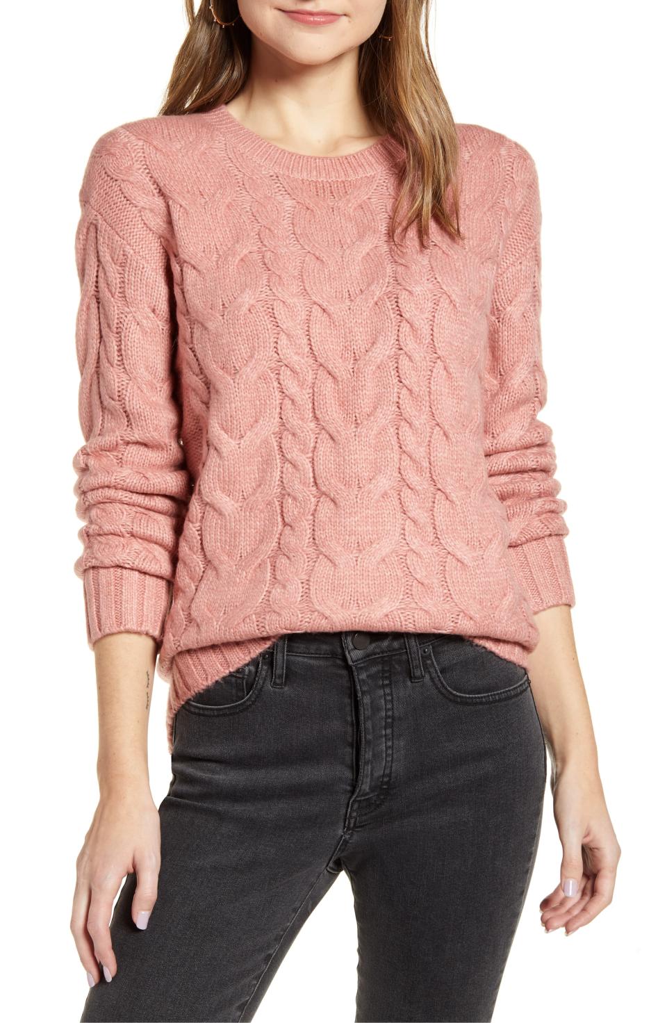 A classic braided cable knit sweater in a soft pastel pink. 