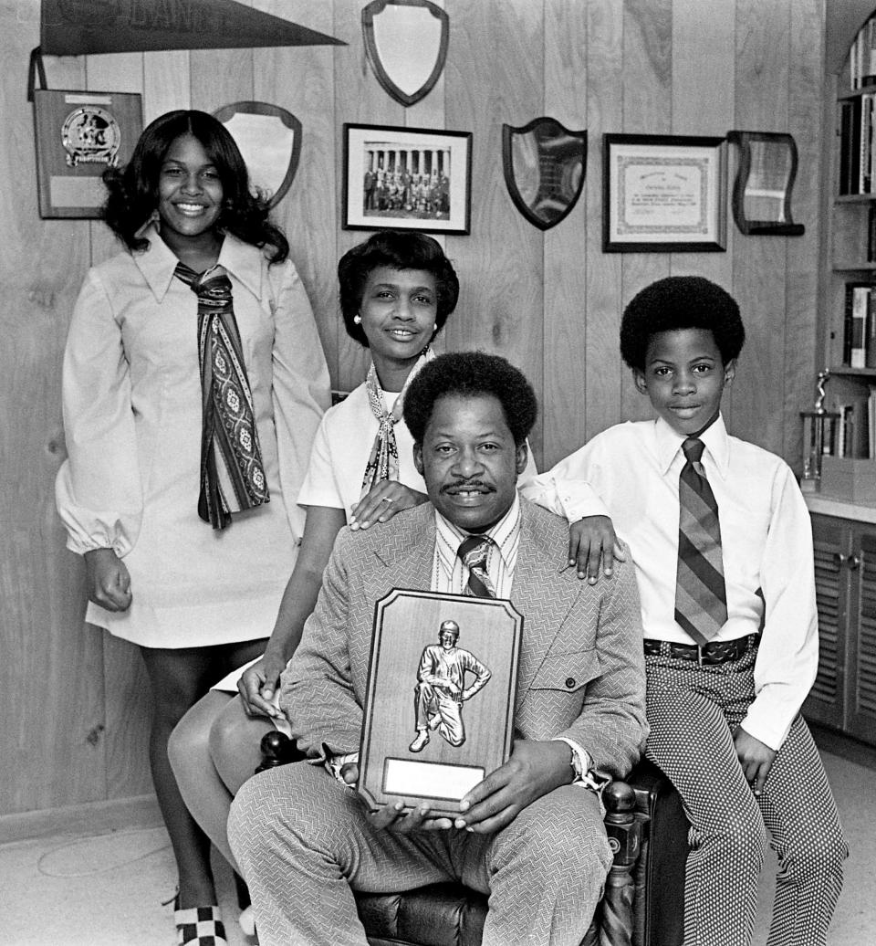 Pearl High Coach Cornelius Ridley, center, holds the Tennessean’s NIL Coach of the Year plaque March 26, 1973, while surrounded by his family, wife Josephine, left, daughter Constance and son Keith. Coach Ridley, the winningest active coach in the NIL, was vote the basketball coach of the year by his colleagues. Oddly enough, it comes at the end of his worst season in 13 years of coaching, a lackluster 18-10 campaign.