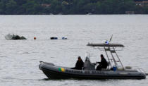 Rescue workers are seen near the wreckage from a plane, which crashed with Brazilian Supreme Court Justice Teori Zavascki, who was overseeing a graft investigation into scores of powerful politicians, in Paraty, Rio de Janeiro state, Brazil, January 20, 2017. REUTERS/Bruno Kelly