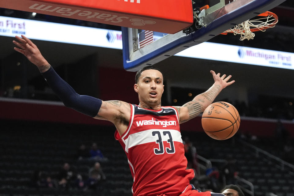 Washington Wizards forward Kyle Kuzma (33) dunks against the Detroit Pistons in the second half of an NBA basketball game in Detroit, Saturday, Jan. 27, 2024. (AP Photo/Paul Sancya)