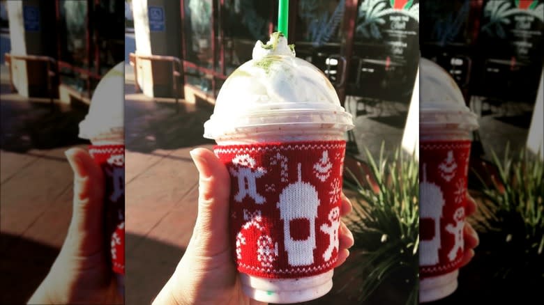 person holding fruitcake frappuccino