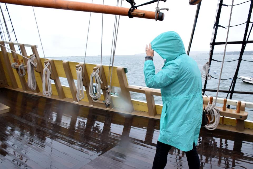 Like it did in 1620, the weather at Plymouth, Massachusetts, includes plenty of rain, prompting this tourist to wear a slicker in September 2023 on the replica ship Mayflower II.