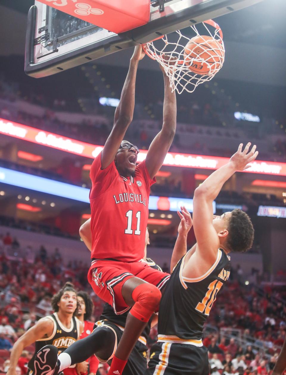 Louisville Cardinals center Dennis Evans (11) slams down two against UMBC Monday night at the Cardinals men's basketball season opener. Nov.6, 2023.