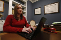 Rebecca Courtright works on her computer at her home Thursday, Feb. 6, 2020, in Powhatan, Va. After being raped in 2003 Courtright agreed to allow a police officer to drive her to another hospital, about 30 minutes away. There, she was treated by a sexual assault nurse examiner who calmed her, collected evidence from her body and "made an intrusive examination not so jarring." (AP Photo/Steve Helber)