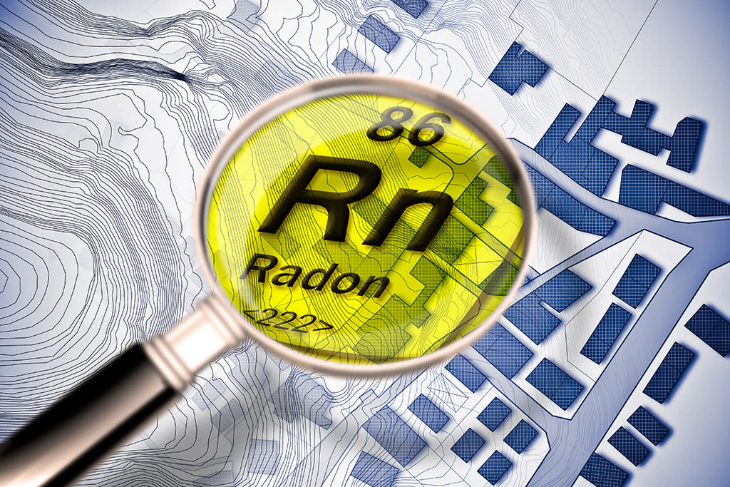 The dangerous radioactive radon gas in our cities - concept image with periodic table of the elements, magnifying lens and city map on background