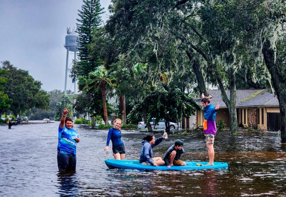 Edgewater resident Allison Barker, pictured third from the right, can be seen in a kayak checking out the flooding that Tropical Storm Ian caused in her neighborhood along with family members and neighbors in the on Thursday afternoon, Sept. 29, 2022. The road pictured here is Kumquat Drive, which is one block over from Barker's house. It remained flooded as of Friday morning, she reported. "The water made it up to my porch, but not inside my house," she said.