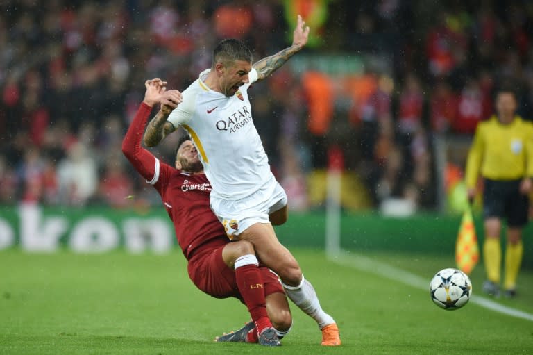 Liverpool midfielder Alex Oxlade-Chamberlain (left) picks up an injury tackling Roma defender Aleksandar Kolarov at Anfield